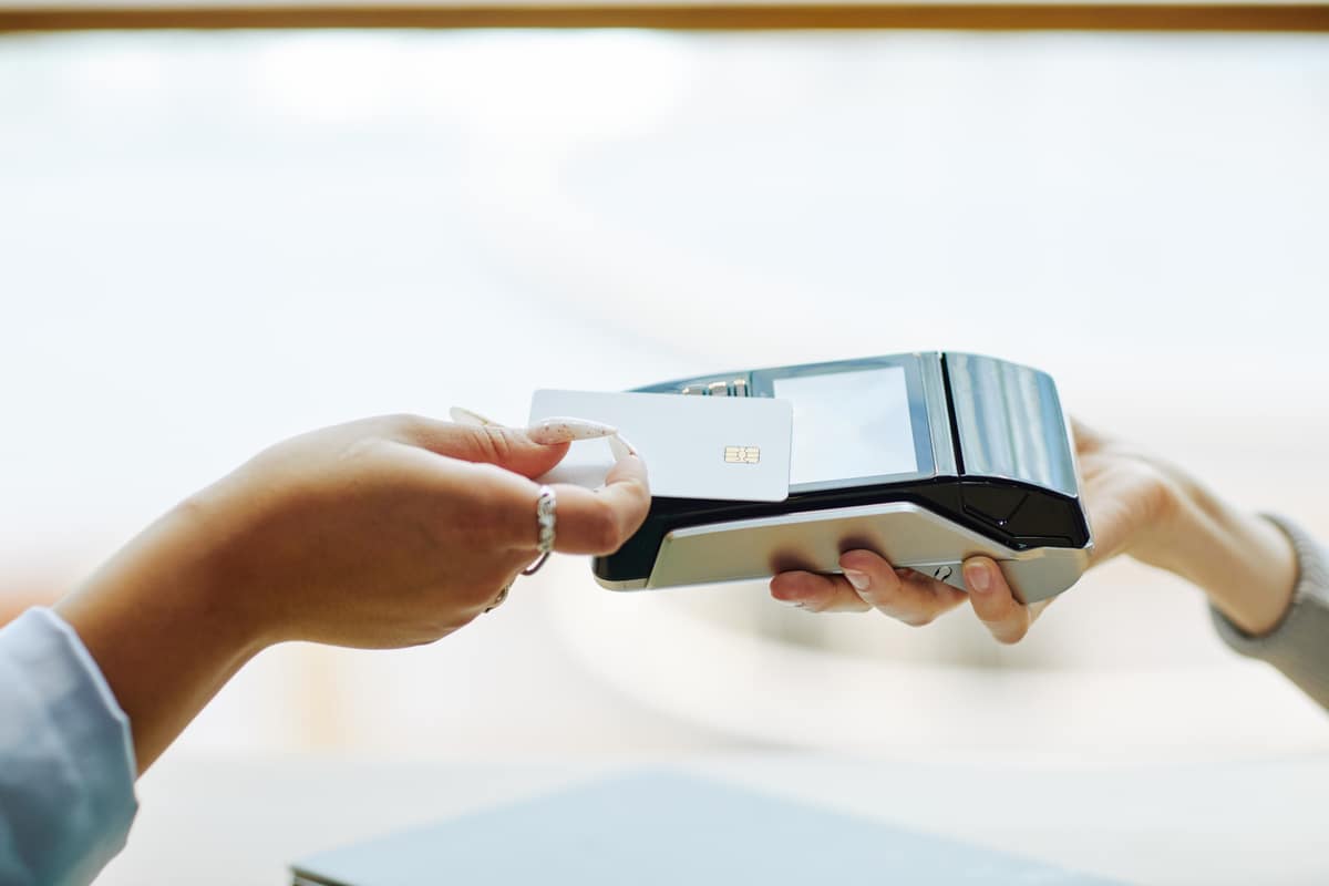 A close-up of a card being tapped on a payment terminal
